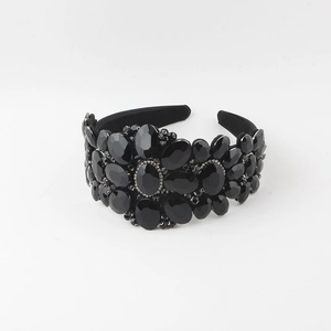 Detail view of Baroque wide headband with dense sparkling glass rhinestones on black fabric