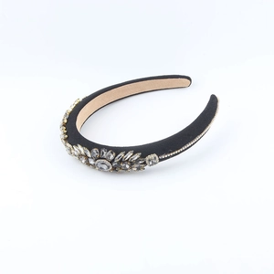 Detail of baroque black velvet headband with sparkling grey crystals and intricate patterns