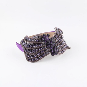 Detailed view of luxury purple headband featuring hand-sewn crystals and floral beadwork