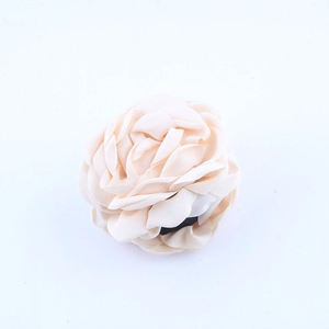 Dettaglio di un fermaglio per capelli a rosa in chiffon beige con petali in tessuto