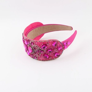 Detail of rose red baroque headband with pink rhinestones and velvet lining