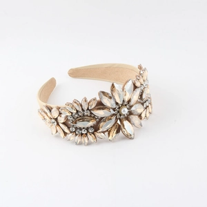Detail of luxury padded headband with champagne crystals and white pearls in floral patterns