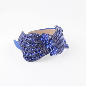 Detail of luxury royal blue rhinestone headband with intricate crystal flower patterns