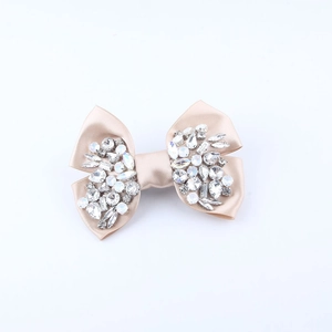 Champagne satin bow hair clip with sparkling rhinestones and drop-cut crystal accents