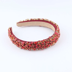 Detail of red velvet headband featuring luxurious rhinestones and ruby-like crystals