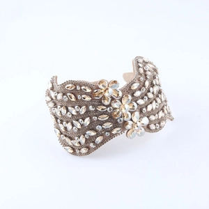 Macro detail of luxury headband with sparkling amber crystals and floral rhinestone patterns