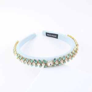 Sparkling light blue sponge headband featuring green leaf-shaped rhinestones and crystals