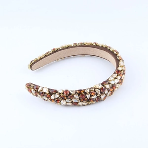 Detail of baroque wide headband with amber rhinestones on velvet material