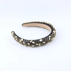 Macro detail of Baroque headband featuring dense black crystals and gold metal claws