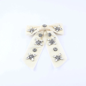 Elegant velvet cream bow hair clip with sparkling rhinestone clusters for festive styling