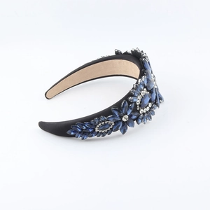 Elegant navy blue crystal flower headband with rhinestones on a black velvet base