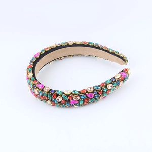 Detailed view of colorful rhinestones on a thick headband with plush lining
