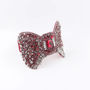 Detailed macro view of handcrafted Baroque red rhinestone bow headband with crystal gems