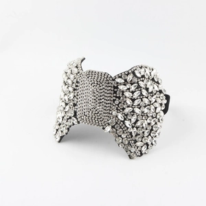Detailed close-up of large black bow headband with shimmering crystal rhinestones