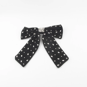 Elegant black velvet hair clip with sparkling rhinestones in a large bow design