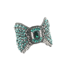 Baroque emerald bow headband with full rhinestones on a minimalist white background