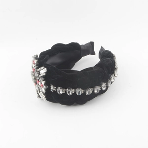 Detail of black velvet padded headband with sparkling rhinestones and crystal cross