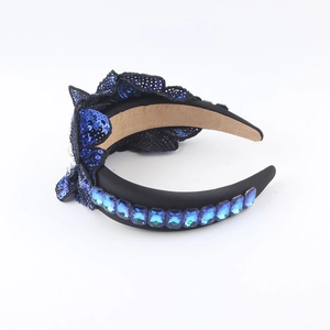 Detail of baroque headband with blue sequins and rectangular crystals on black fabric