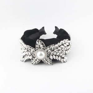 Fashionable black velvet headband with rhinestone star and central pearl for women