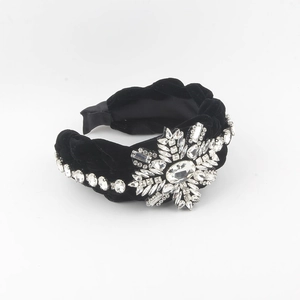 Elegant black velvet headband featuring a large sparkling rhinestone snowflake design