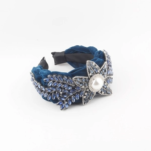 Navy blue velvet headband with sparkling rhinestones and a central pearl flower accent