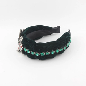 Detailed macro shot of deep green velvet braided headband with rhinestones