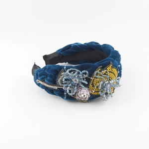 Detail showing braided velvet headband with 3D floral beads and rhinestone embellishments