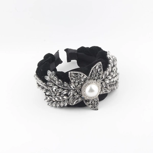Luxurious velvet twisted headband with floral rhinestones and central white pearl accent