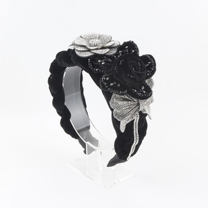 Detail of vintage velvet headband with crystal camellia, rose, and bowknot accents