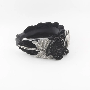 Detail of black velvet braided headband with rose flower, rhinestone bow and beads