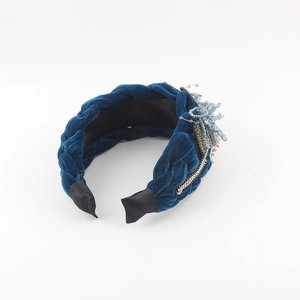 Detail of dark blue woven velvet headband with intricate crystal and floral beadwork
