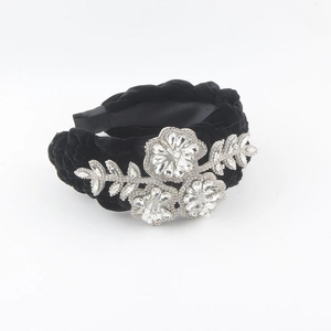 Luxurious black velvet braided headband with sparkling rhinestone leaf and floral accents
