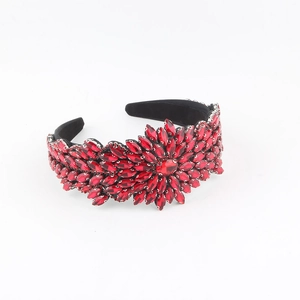 Detail of red baroque headband with crystal flower pattern on a black fabric base