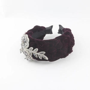 Detail of braided purple velvet headband with sparkling rhinestone leaf ornaments