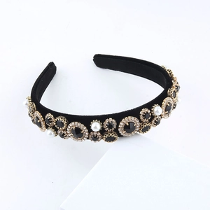 Baroque style velvet headband with black rhinestones and pearls on white background