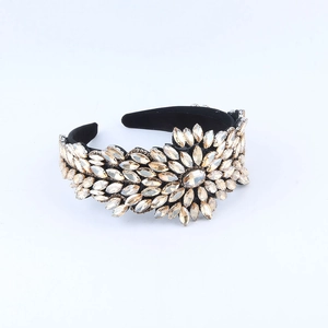 Detailed close-up of Baroque padded headband with champagne rhinestones on black velvet