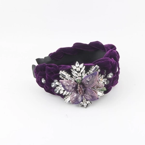 Deep purple velvet headband with handcrafted rhinestone flower and braided fabric design