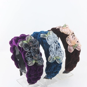 Detail of velvet braided headbands with handmade beadwork and crystal flower embroidery