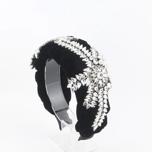 Detail view of thick black velvet headband with luxury sparkling rhinestone patterns