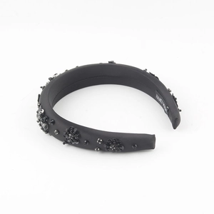 Elegant black padded headband with handcrafted bead flowers and satin finish