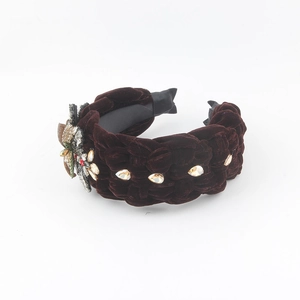 Detail of burgundy velvet braided headband with champagne crystals and floral rhinestones