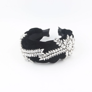 Luxe black velvet headband with sparkling crystal leaf patterns for a high-top look