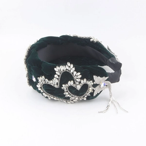 Detail of green velvet braided headband featuring heart rhinestones and tassel charms