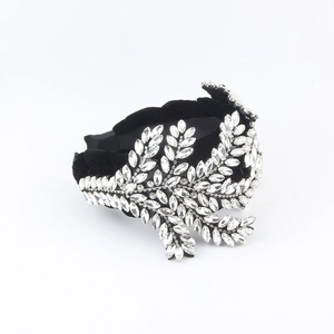 Detailed close-up of Baroque crystal headband with clear rhinestones on black velvet