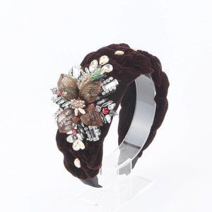 Detailed side view of braided velvet headband with luxury crystal flower ornaments