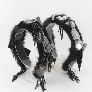 Close-up of luxury faux mink headband featuring rhinestone bows and beaded tassels