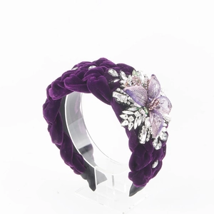 Detail view of purple velvet braided headband with sparkling rhinestones and mesh flower deco