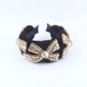 Deep brown velvet wide headband with golden rhinestone bows and white pearls
