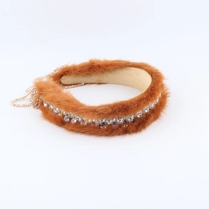 Macro detail of luxury brown mink fur headband with sparkling crystal rhinestones and beads