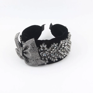 Elegant black velvet headband with sparkling crystal bow and floral rhinestone accents
